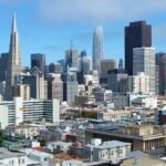 a city skyline with many tall buildings