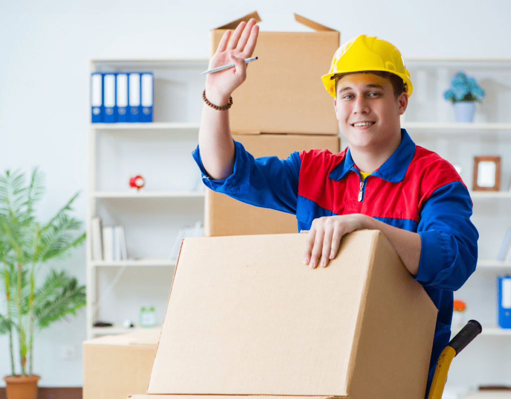 a man in a hat holding a box